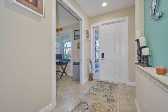 foyer featuring light tile patterned floors and baseboards