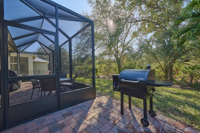 view of patio with a lanai and a grill