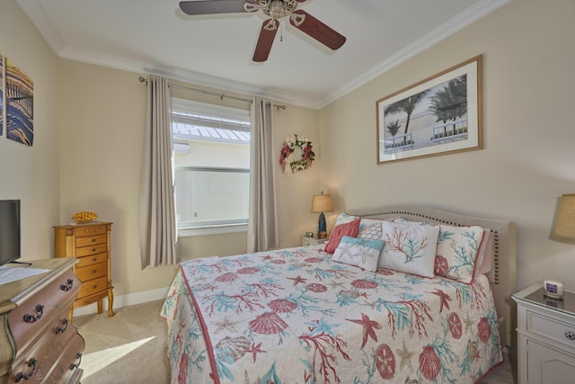 carpeted bedroom featuring ornamental molding, a ceiling fan, and baseboards