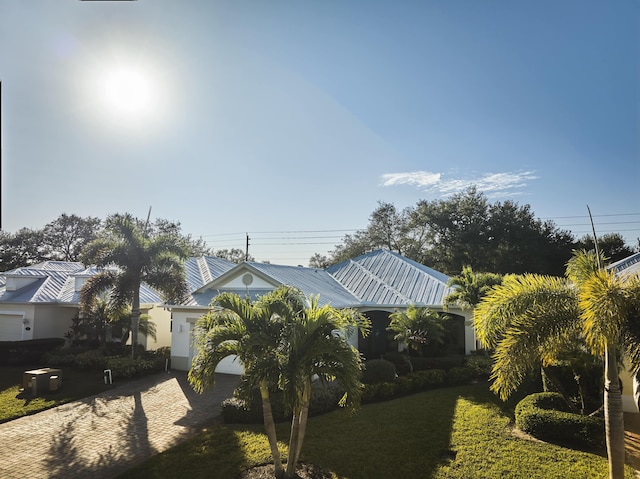 view of front of home featuring metal roof and decorative driveway