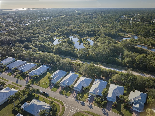 aerial view featuring a residential view, a water view, and a view of trees