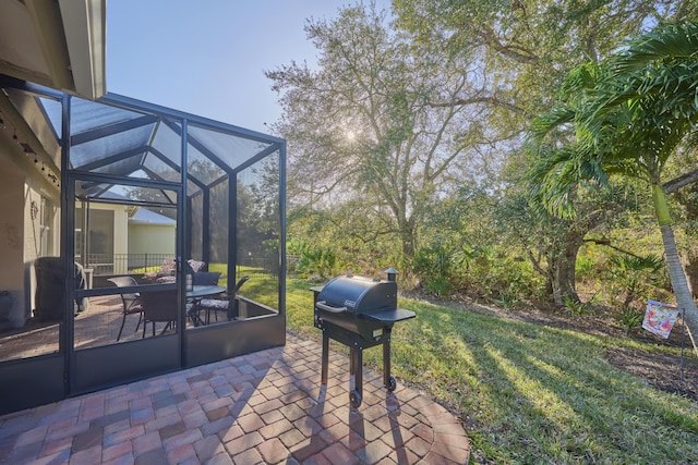 view of patio / terrace with a lanai and a grill