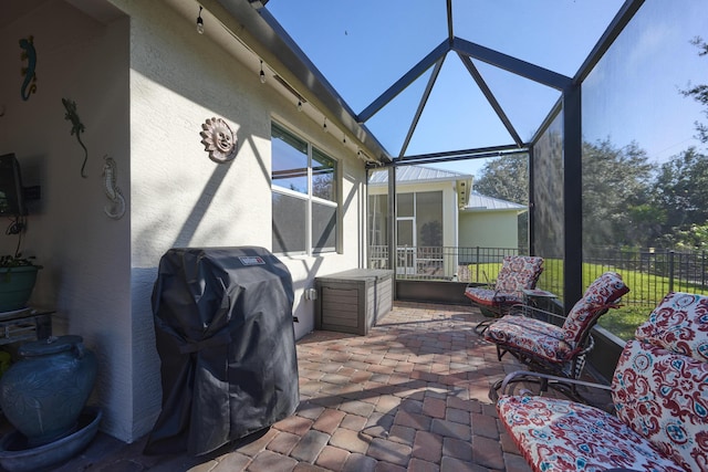 view of patio / terrace with glass enclosure and fence