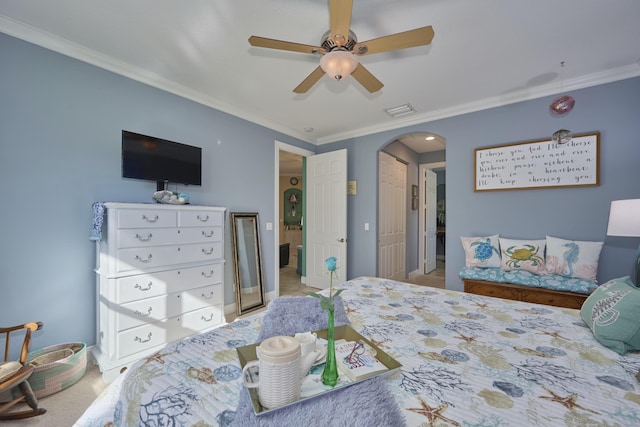 bedroom featuring carpet floors, arched walkways, crown molding, visible vents, and ceiling fan