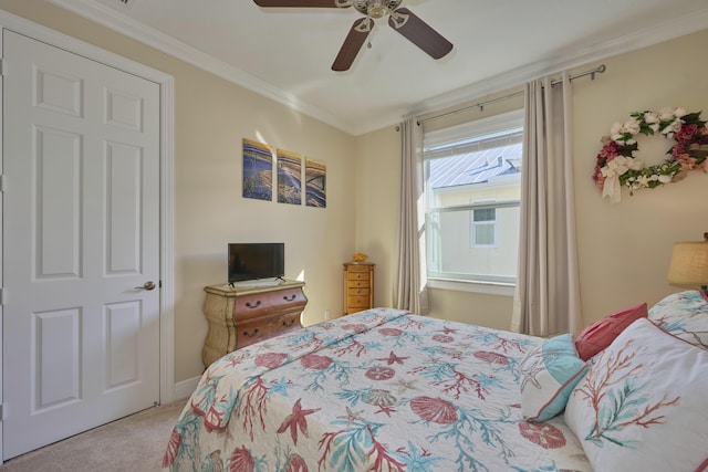 bedroom featuring carpet, ornamental molding, and ceiling fan