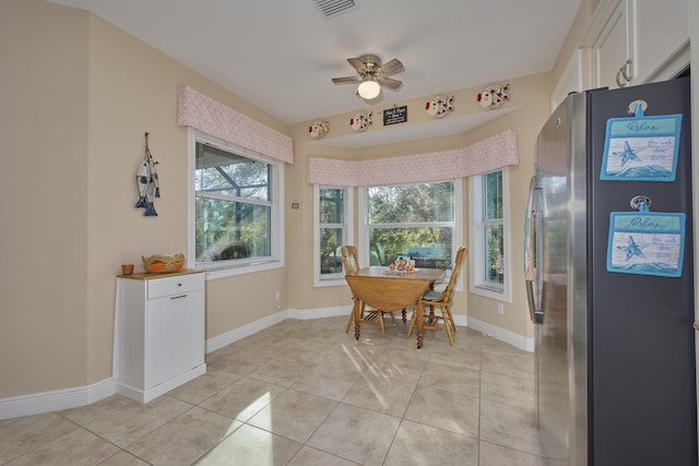 dining room featuring light tile patterned floors, visible vents, baseboards, and a ceiling fan