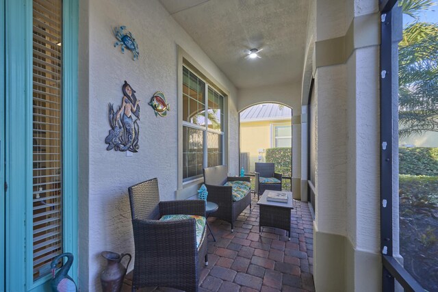 sitting room with baseboards, visible vents, and ornamental molding