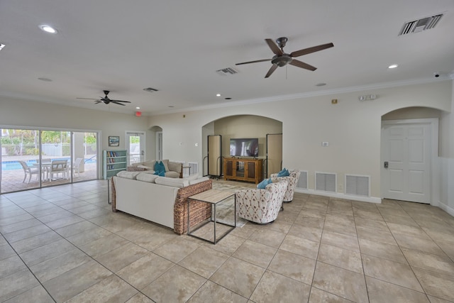 living area with light tile patterned floors, visible vents, and ornamental molding