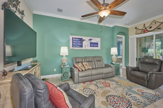 bedroom with light tile patterned floors, ceiling fan, and ornamental molding