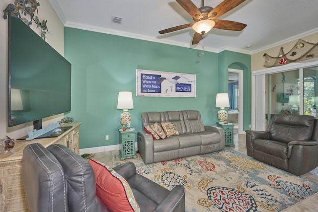 living area with a ceiling fan, visible vents, ornamental molding, and baseboards