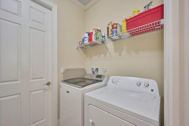 washroom featuring laundry area and separate washer and dryer