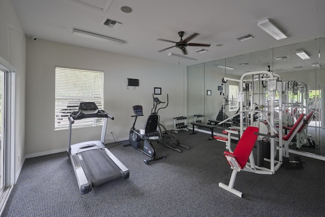 gym with a ceiling fan, visible vents, and baseboards