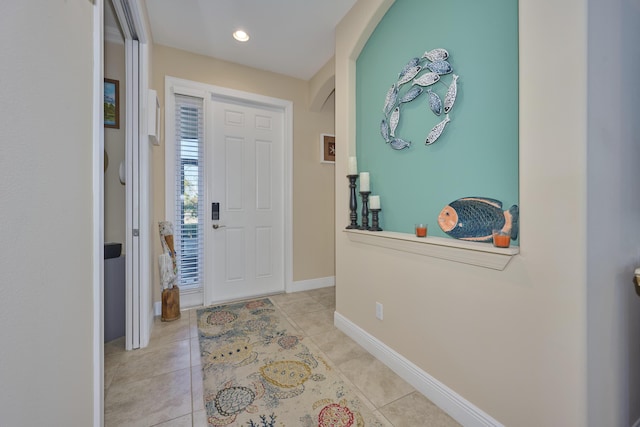 entrance foyer featuring recessed lighting, light tile patterned flooring, and baseboards