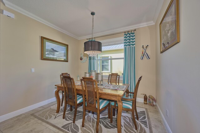 dining room with light tile patterned floors, baseboards, a chandelier, and crown molding