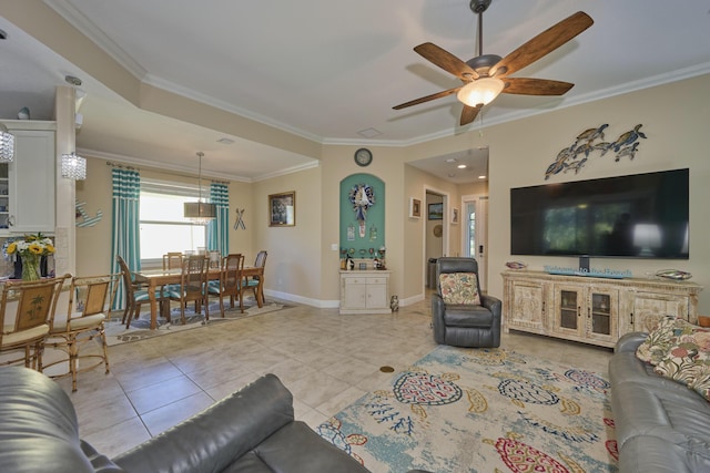 living room with ornamental molding, ceiling fan, baseboards, and light tile patterned floors