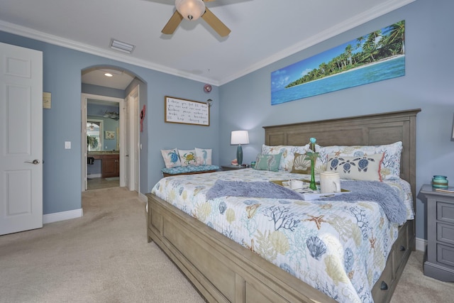 bedroom with baseboards, visible vents, arched walkways, light colored carpet, and crown molding