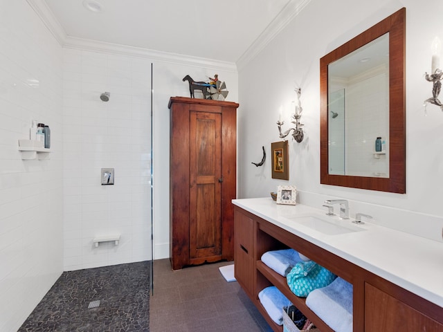 bathroom featuring tiled shower, crown molding, and vanity