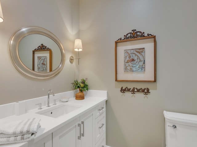 bathroom featuring vanity and toilet