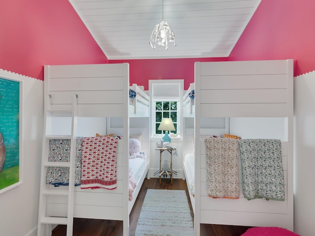 bedroom with lofted ceiling and dark wood-type flooring