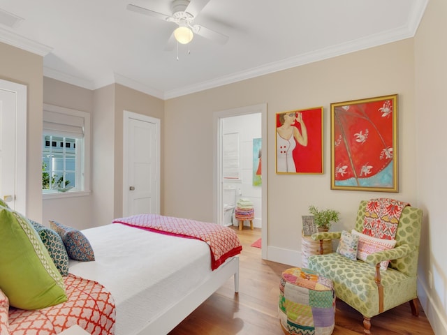 bedroom with hardwood / wood-style flooring, ensuite bath, ceiling fan, and ornamental molding