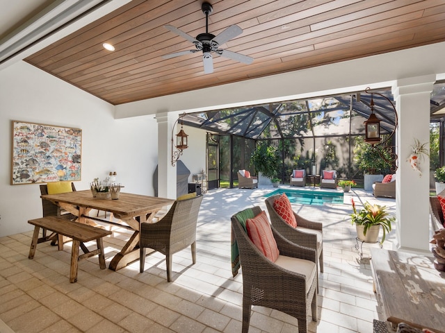 view of patio featuring ceiling fan and a lanai