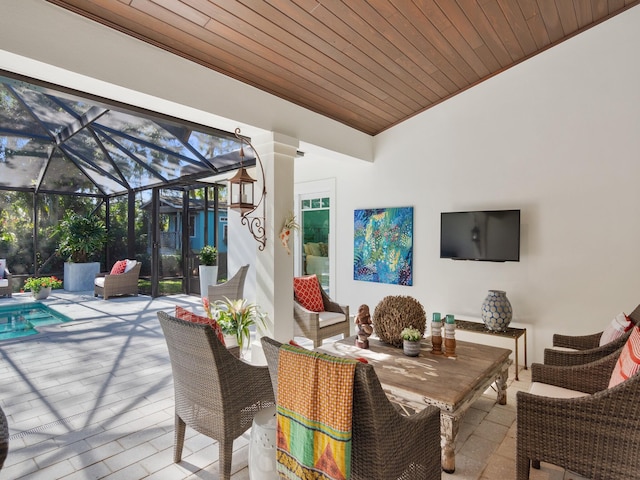 view of patio / terrace featuring glass enclosure