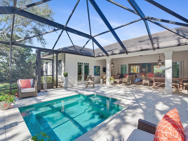 view of swimming pool featuring a lanai, an outdoor hangout area, and a patio