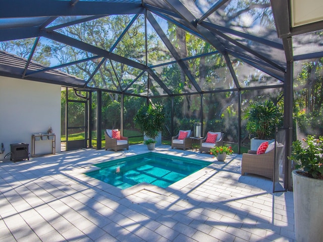 view of swimming pool featuring a lanai and a patio