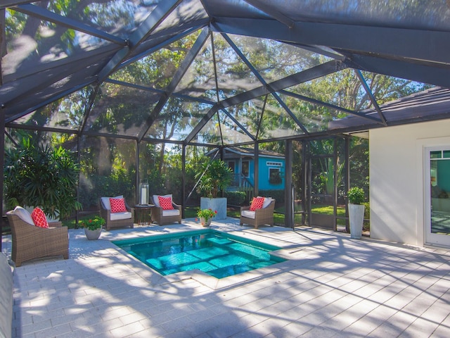 view of pool featuring a lanai, a patio area, and an outbuilding