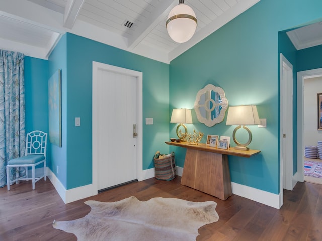 entrance foyer featuring dark hardwood / wood-style floors, beam ceiling, and wooden ceiling