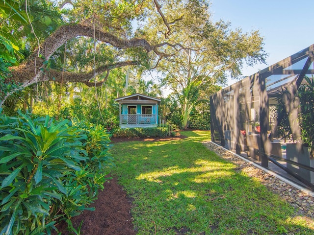 view of yard featuring glass enclosure