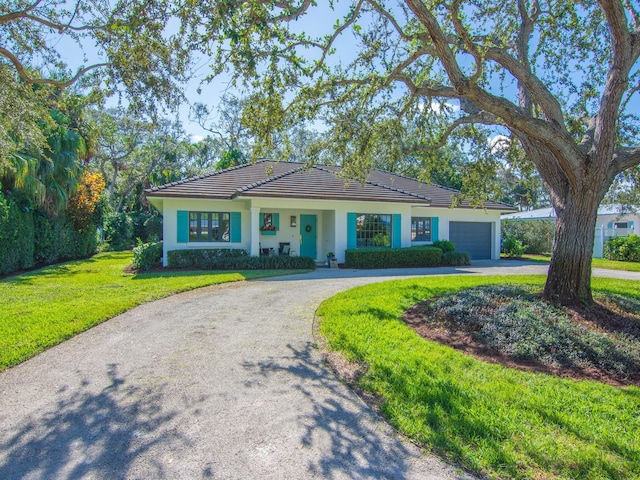 ranch-style home with a front yard and a garage