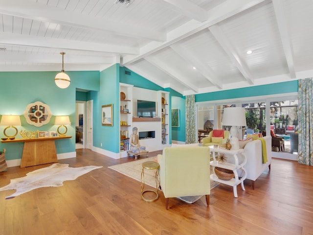 living room featuring lofted ceiling with beams and hardwood / wood-style flooring