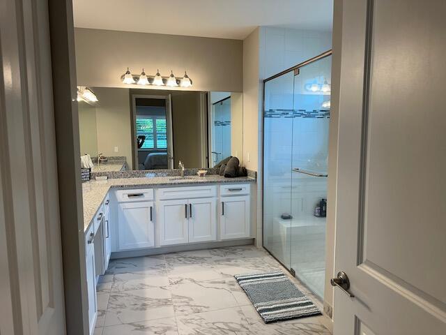 bathroom with vanity and an enclosed shower