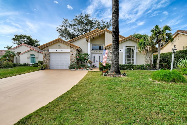 view of front of property with a front yard, driveway, an attached garage, stone siding, and a tile roof