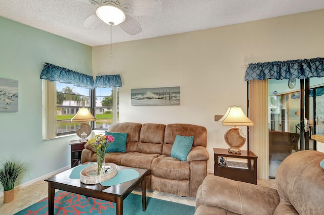 tiled living room with a textured ceiling and ceiling fan