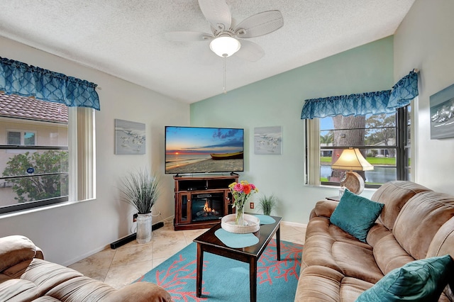 tiled living room featuring a textured ceiling, ceiling fan, and lofted ceiling