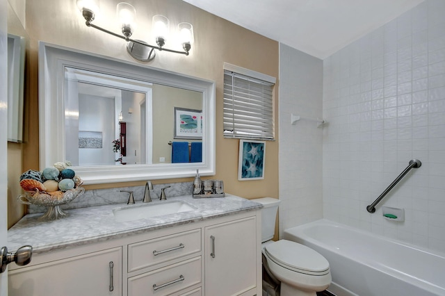 full bathroom featuring toilet, tiled shower / bath combo, and vanity