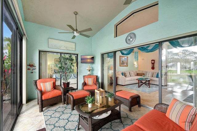 sunroom / solarium with vaulted ceiling, ceiling fan, and a healthy amount of sunlight