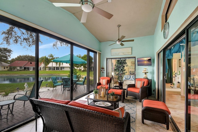 sunroom with ceiling fan, a water view, and vaulted ceiling