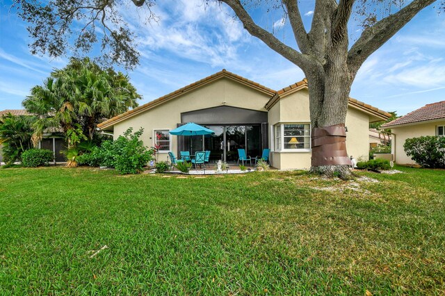 view of front of home with a front lawn, a garage, and a water view