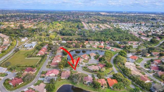 drone / aerial view featuring a water view and a residential view