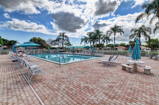 pool featuring a patio area and fence