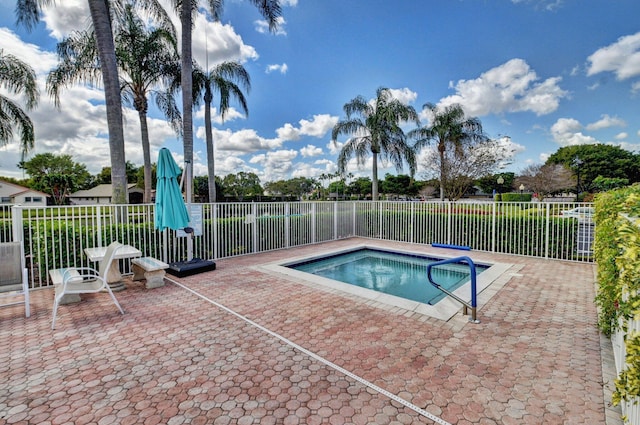 view of swimming pool featuring a patio area and fence