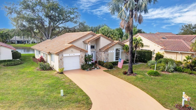 view of front facade with a front lawn, a tiled roof, concrete driveway, stucco siding, and a garage