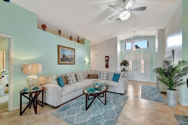 tiled living room featuring high vaulted ceiling, ceiling fan, and a textured ceiling