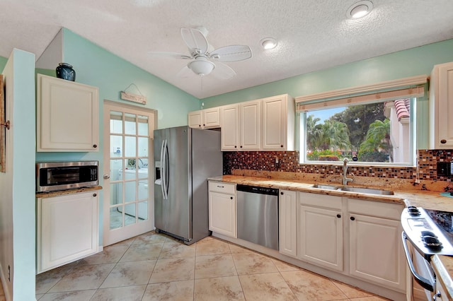 kitchen featuring sink, stainless steel appliances, backsplash, and ceiling fan