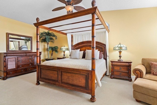 carpeted bedroom featuring a textured ceiling, ceiling fan, and lofted ceiling