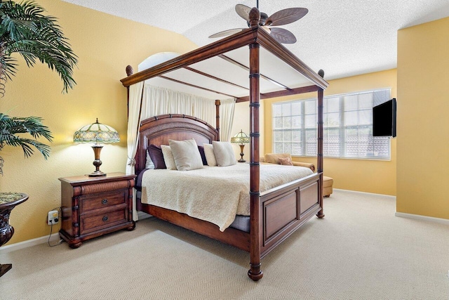 bedroom featuring vaulted ceiling, ceiling fan, and light colored carpet