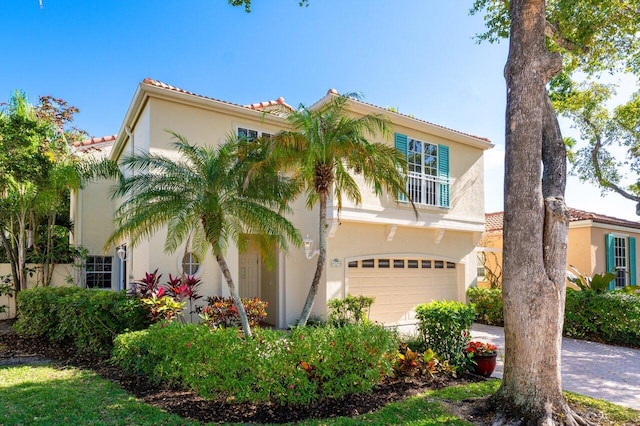 mediterranean / spanish-style house with a garage